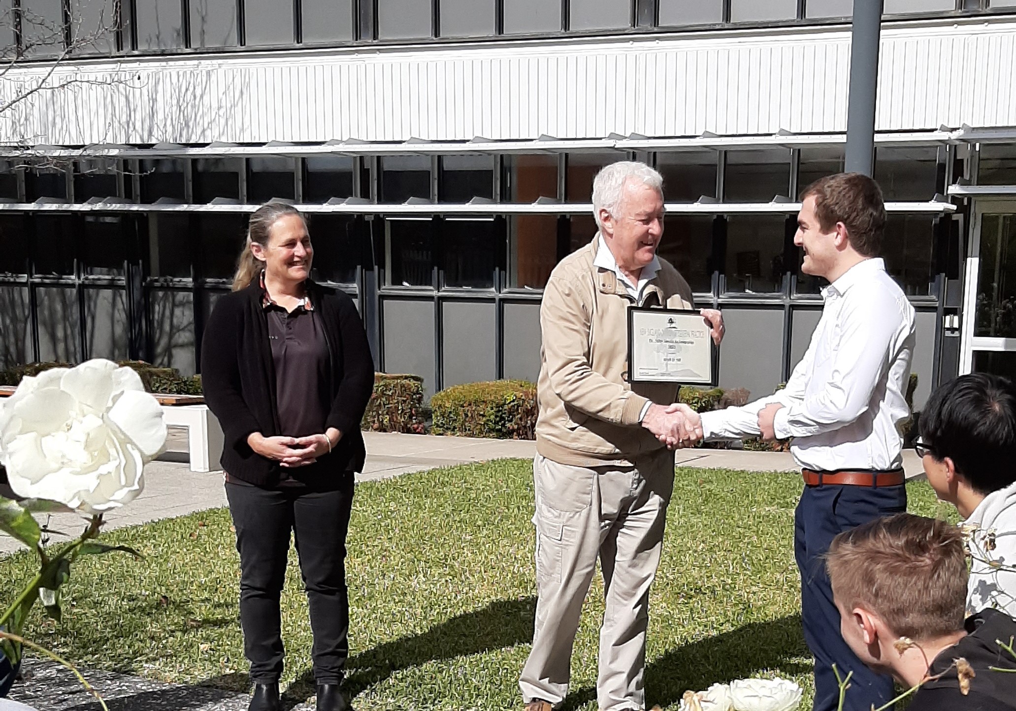 Matt St Hill receiving his award from Dr John Nevin and Dr Michelle Guppy in 2021